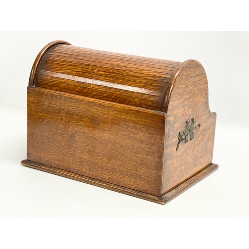 21 - A late Victorian oak desktop stationary box with tambour roll top. 31x22x23cm