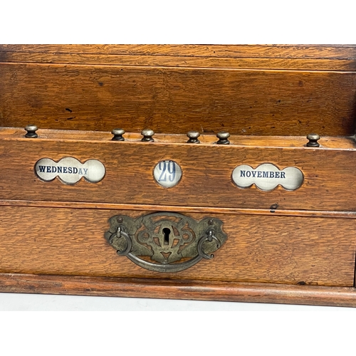 21 - A late Victorian oak desktop stationary box with tambour roll top. 31x22x23cm