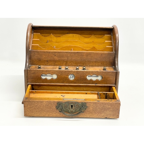 21 - A late Victorian oak desktop stationary box with tambour roll top. 31x22x23cm