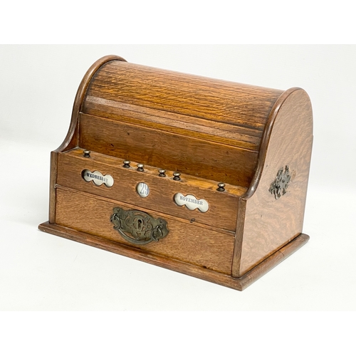 21 - A late Victorian oak desktop stationary box with tambour roll top. 31x22x23cm