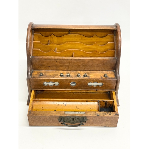 21 - A late Victorian oak desktop stationary box with tambour roll top. 31x22x23cm