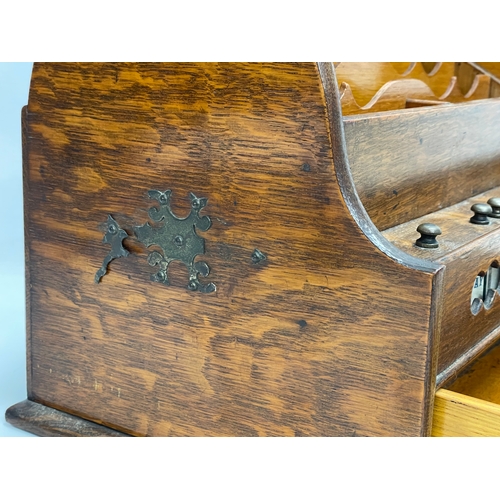 21 - A late Victorian oak desktop stationary box with tambour roll top. 31x22x23cm