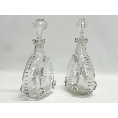 24 - A pair of Remi Martin Baccarat Glass cognac decanters. 16x28cm