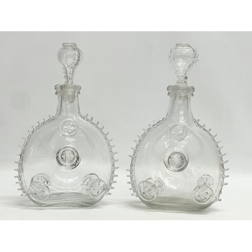 24 - A pair of Remi Martin Baccarat Glass cognac decanters. 16x28cm