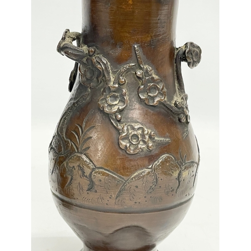 73 - A pair of late 19th century Japanese bronze vases. 20cm