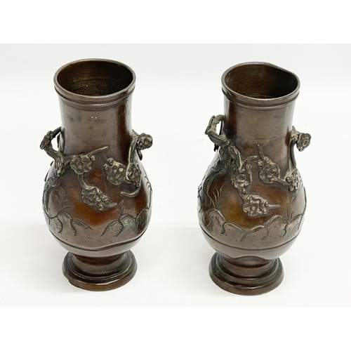 73 - A pair of late 19th century Japanese bronze vases. 20cm