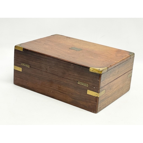 113 - A Victorian rosewood brass bound stationary box. 29.5x22x12cm