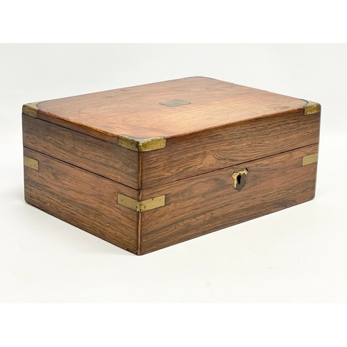 113 - A Victorian rosewood brass bound stationary box. 29.5x22x12cm