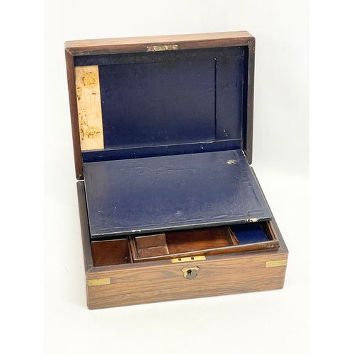 113 - A Victorian rosewood brass bound stationary box. 29.5x22x12cm