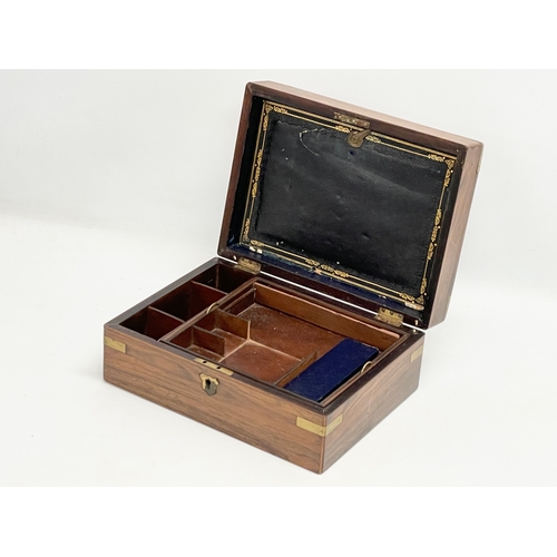 113 - A Victorian rosewood brass bound stationary box. 29.5x22x12cm