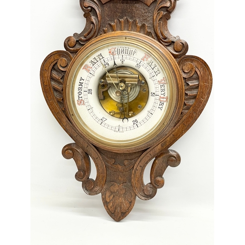 53 - A large Victorian carved oak barometer. 36x98cm