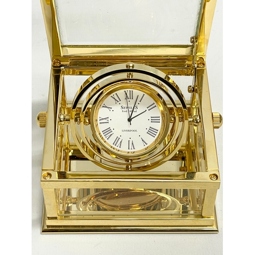 181 - A good quality Sewills ‘Ark Royal’ brass desk clock with box. Clock measures 9x8.5x5cm