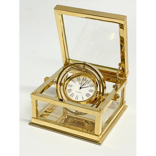 181 - A good quality Sewills ‘Ark Royal’ brass desk clock with box. Clock measures 9x8.5x5cm