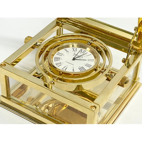 181 - A good quality Sewills ‘Ark Royal’ brass desk clock with box. Clock measures 9x8.5x5cm