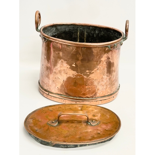 193 - A large Victorian copper 2 handled pot with lid. 34x24x30cm