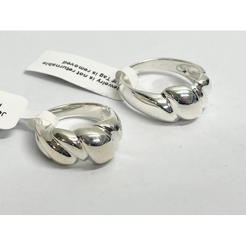 473 - A pair of silver rings. 9.81 grams total.