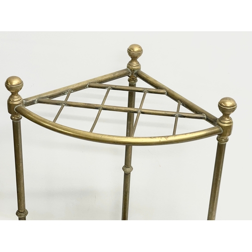 139 - A late Victorian brass stick stand with cast iron base. 42x29x63cm