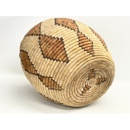 241 - A vintage Zulu Ukhamba basket and an Africa tribal carrying basket. 39x41cm