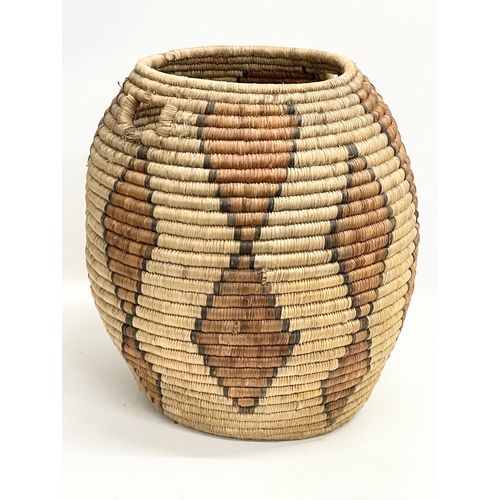 241 - A vintage Zulu Ukhamba basket and an Africa tribal carrying basket. 39x41cm