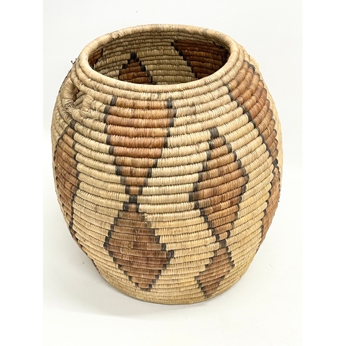 241 - A vintage Zulu Ukhamba basket and an Africa tribal carrying basket. 39x41cm