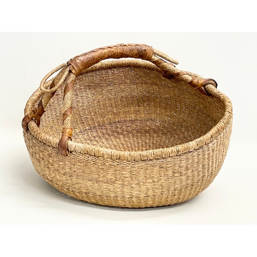 241 - A vintage Zulu Ukhamba basket and an Africa tribal carrying basket. 39x41cm