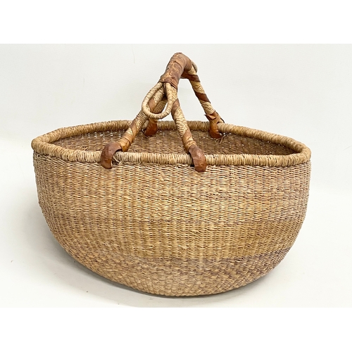 241 - A vintage Zulu Ukhamba basket and an Africa tribal carrying basket. 39x41cm