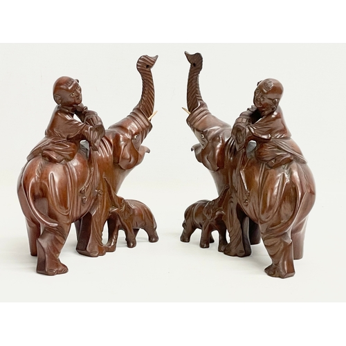 201 - A pair of vintage Chinese Boxwood elephants with riders. 17x20cm