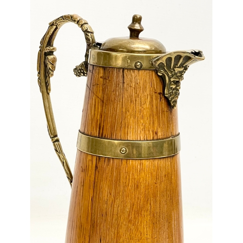 204 - A large late 19th/early 20th century oak brass bound pitcher. Circa 1900. 18x29.5cm