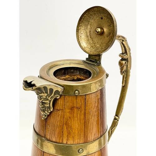 204 - A large late 19th/early 20th century oak brass bound pitcher. Circa 1900. 18x29.5cm