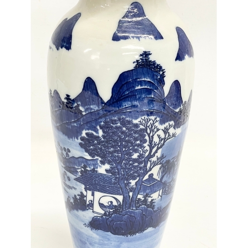 142 - A 19th century Chinese blue and white landscape vase. 30.5cm