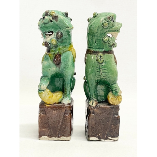 145 - A pair of late 19th Chinese Sancai Glazed porcelain dogs. 16cm.