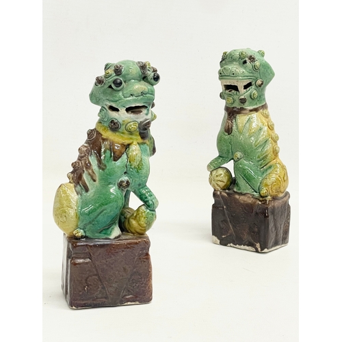 145 - A pair of late 19th Chinese Sancai Glazed porcelain dogs. 16cm.