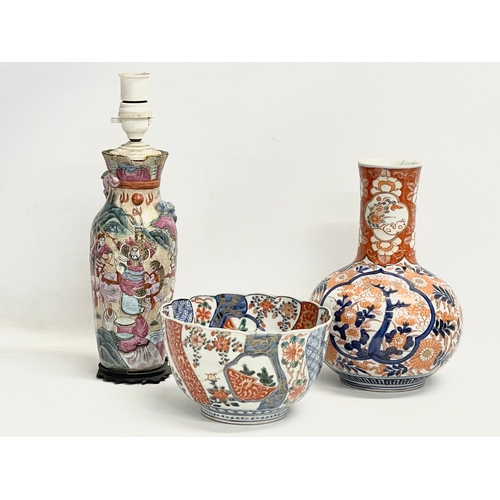 146 - A collection of 19th century Japanese porcelain. A large mid 19th century Japanese Imari pattern bot... 