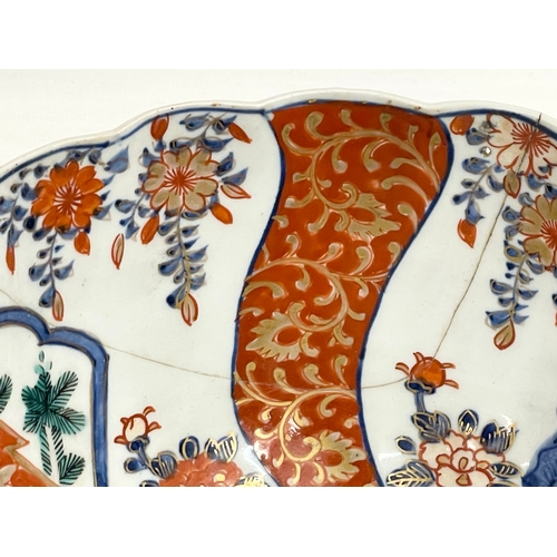 146 - A collection of 19th century Japanese porcelain. A large mid 19th century Japanese Imari pattern bot... 