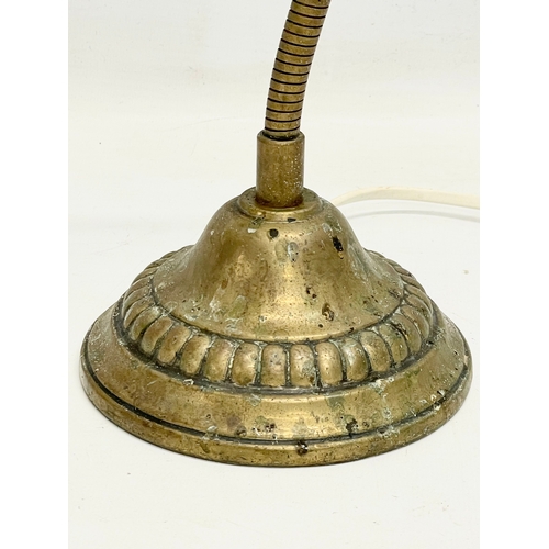 245 - A 1930’s brass adjustable swan neck table lamp. 44cm