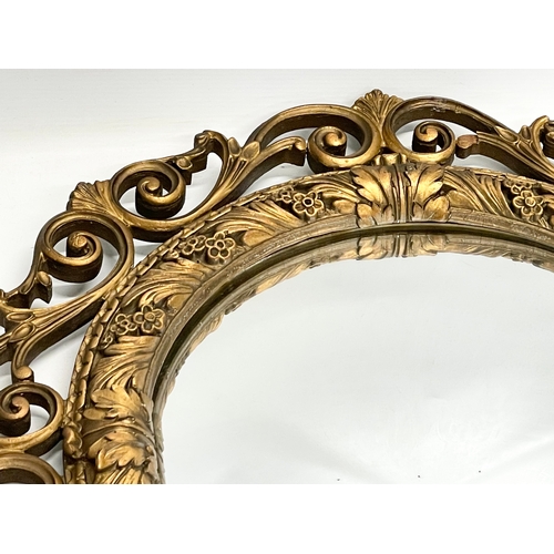 206 - A vintage ornate gilt framed convex mirror by Atsonea. 58cm