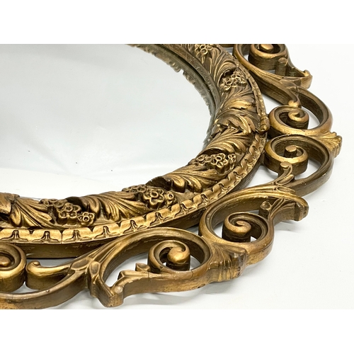 206 - A vintage ornate gilt framed convex mirror by Atsonea. 58cm