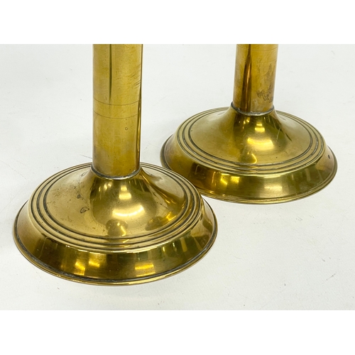 172 - A pair of early 20th century brass candlesticks. 23cm