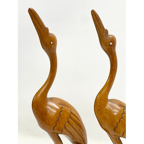 150D - A pair of large 1970’s Mid Century teak cranes. 40cm