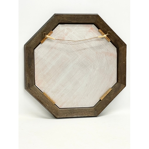 206B - An early 20th century oak framed bevelled mirror. 43.5cm