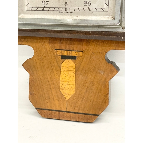 261A - An early 20th century inlaid mahogany barometer. 21x58cm.