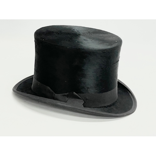 34 - A Victorian leather hat box with a Christie’s of London top hat.