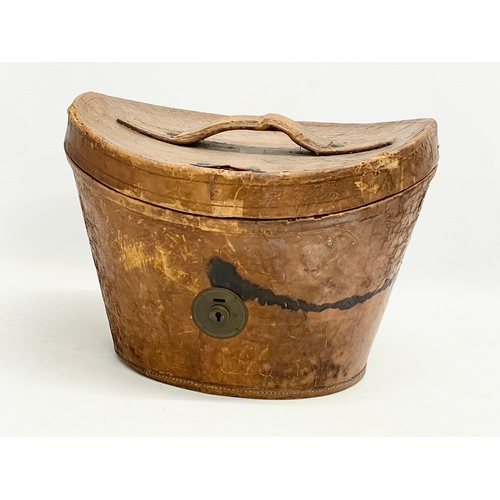 34 - A Victorian leather hat box with a Christie’s of London top hat.