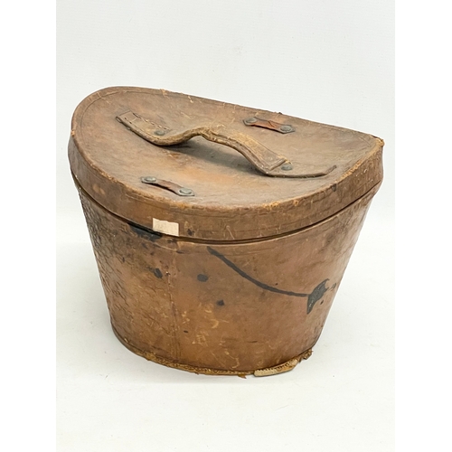 34 - A Victorian leather hat box with a Christie’s of London top hat.