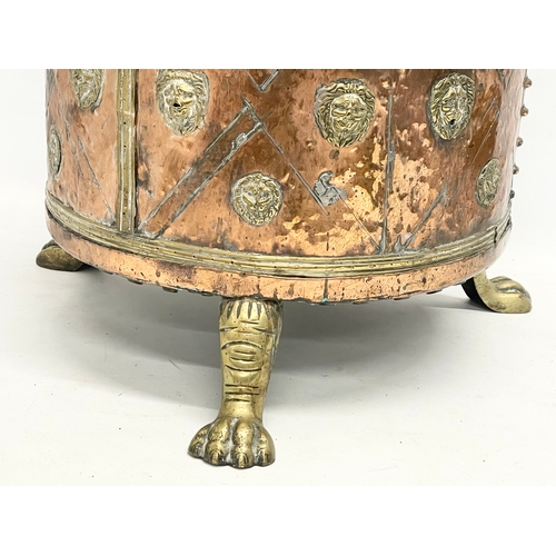 35 - A large Victorian copper and brass coal coal bucket on brass lion paw feet and lion head mouldings. ... 