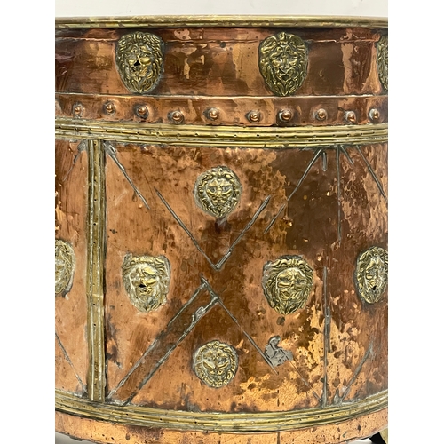 35 - A large Victorian copper and brass coal coal bucket on brass lion paw feet and lion head mouldings. ... 