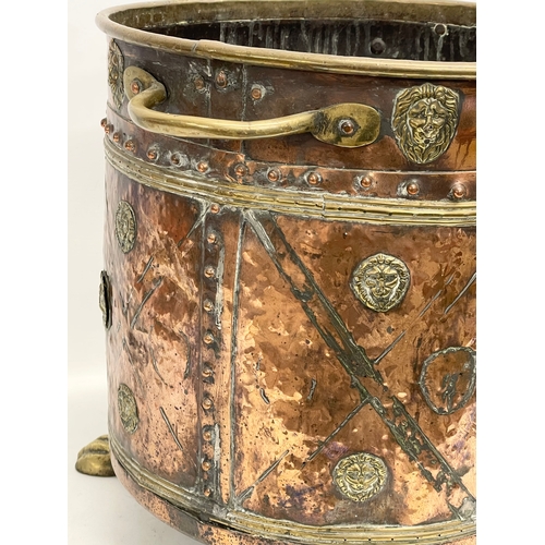 35 - A large Victorian copper and brass coal coal bucket on brass lion paw feet and lion head mouldings. ... 