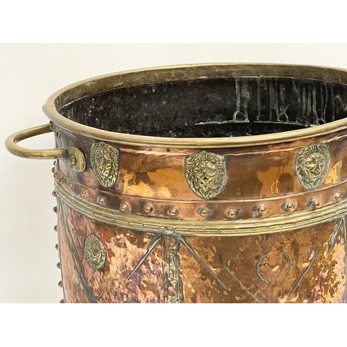 35 - A large Victorian copper and brass coal coal bucket on brass lion paw feet and lion head mouldings. ... 