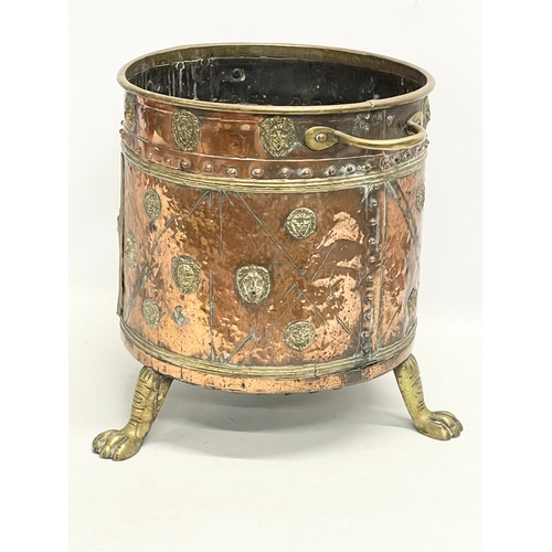 35 - A large Victorian copper and brass coal coal bucket on brass lion paw feet and lion head mouldings. ... 