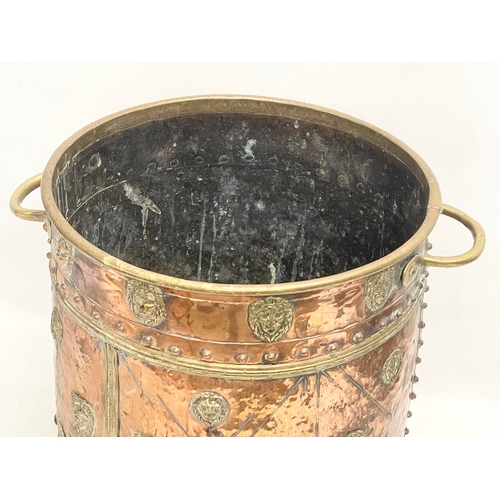 35 - A large Victorian copper and brass coal coal bucket on brass lion paw feet and lion head mouldings. ... 